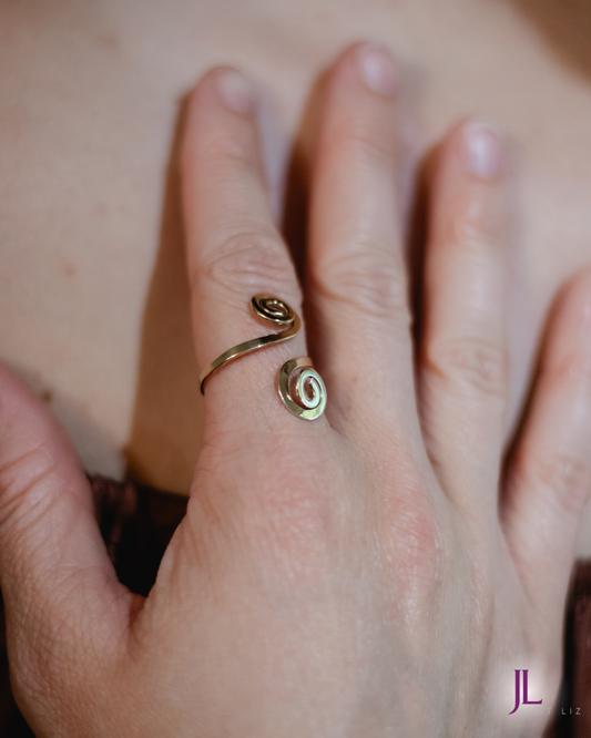 Woman wearing a gold spiral ring on her finger