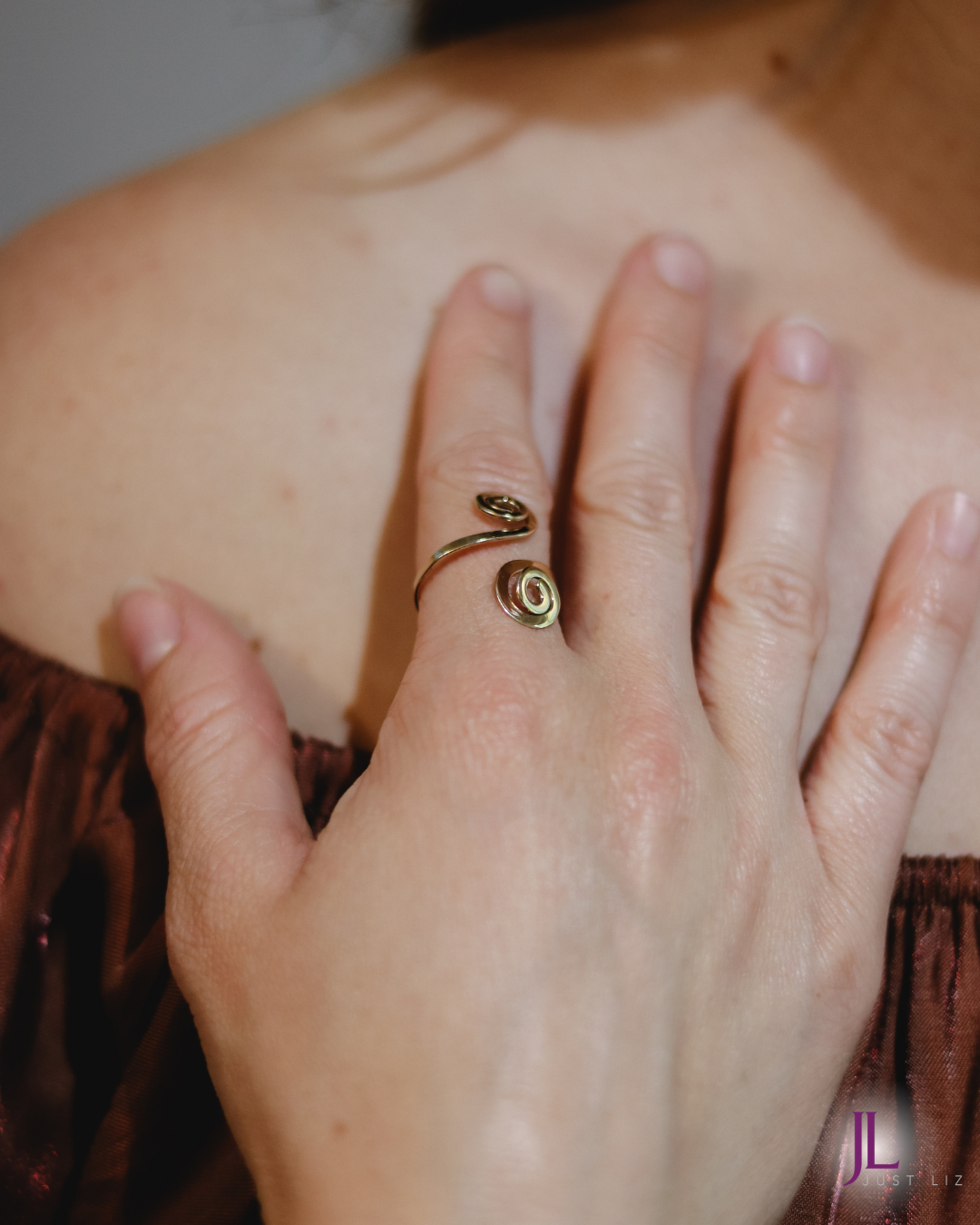 Woman wearing a gold spiral ring on her finger