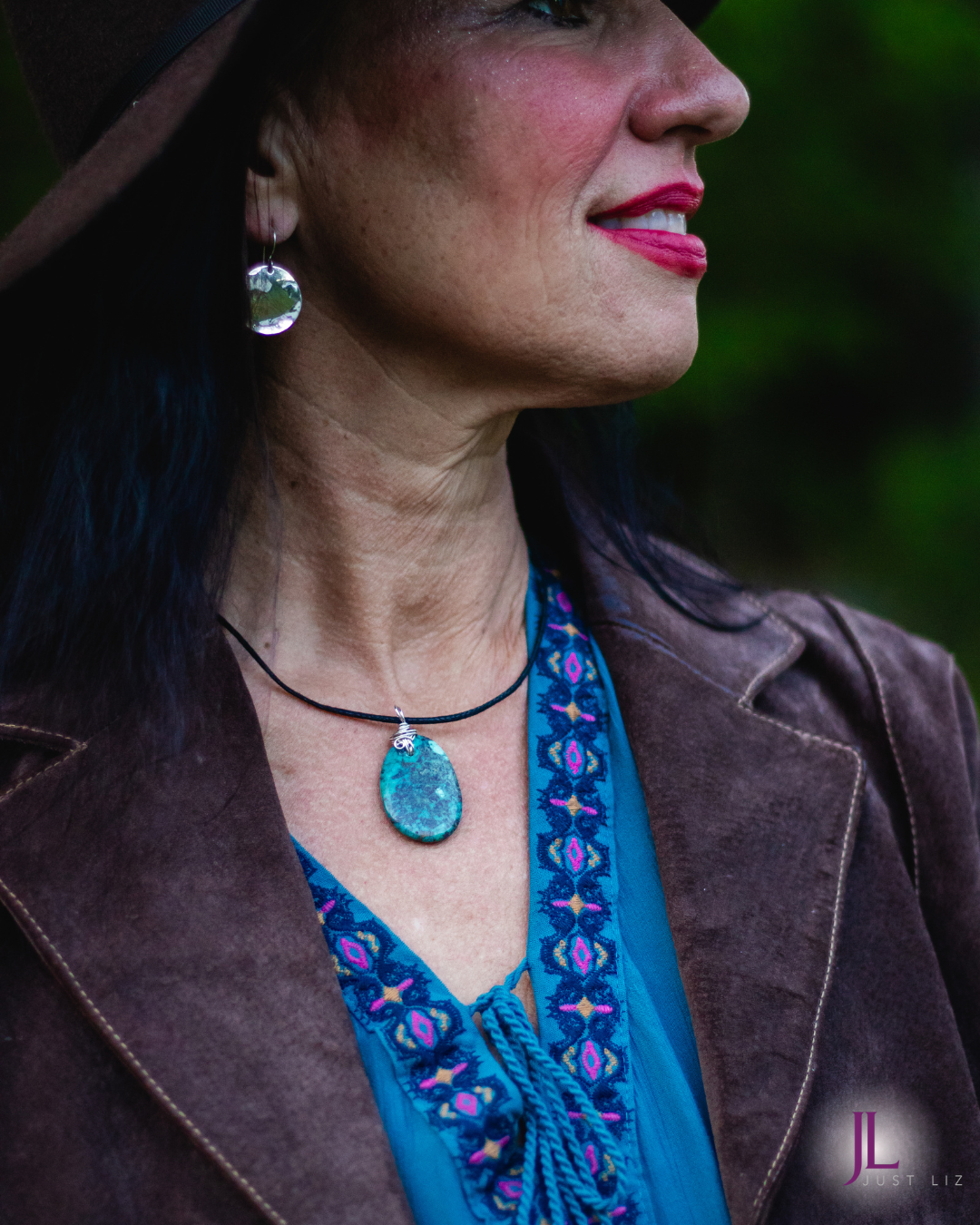 Woman wearing a big round turquoise stone necklace