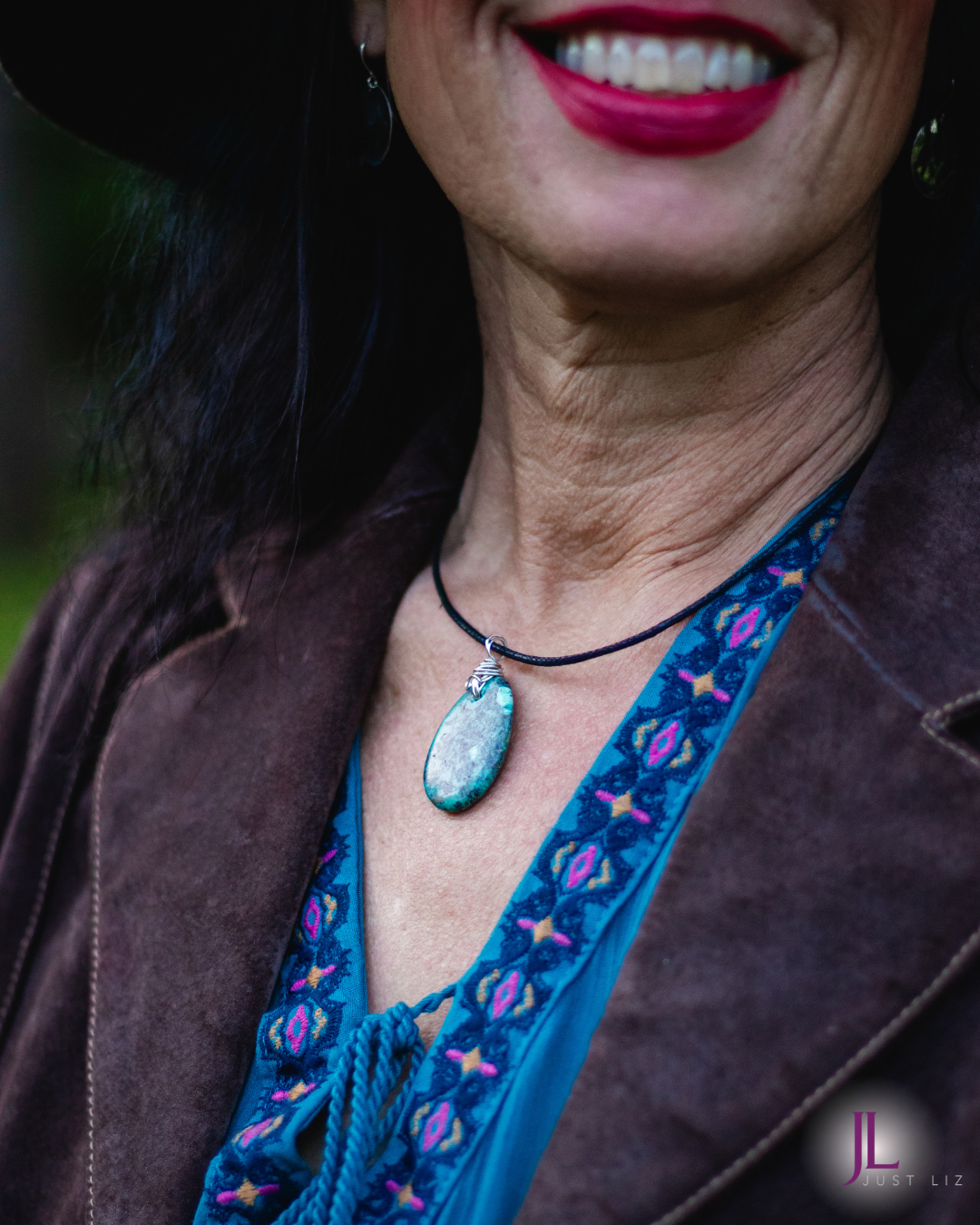 Woman wearing a big round turquoise stone necklace