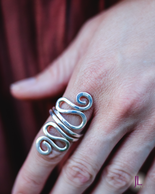 Woman wearing a swirly silver long ring