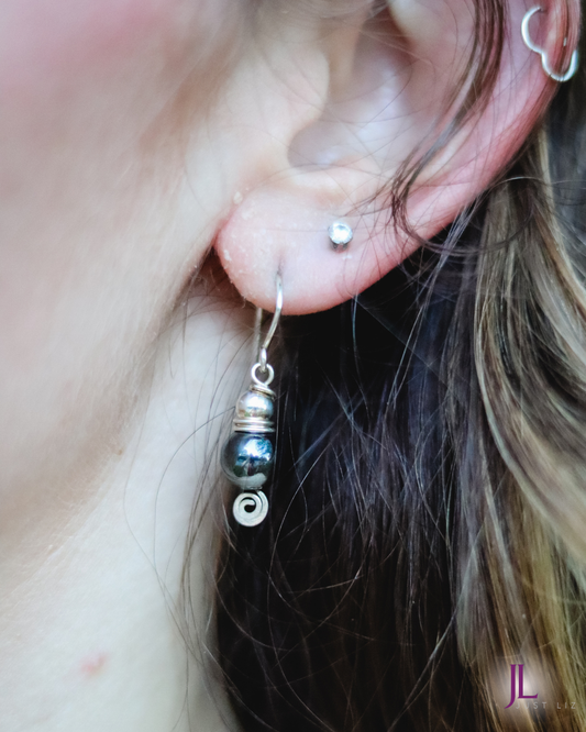 Woman wearing silver and hematite stone dangle earrings
