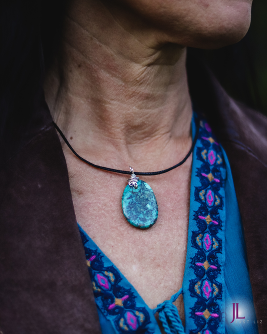 Woman wearing a big round turquoise stone necklace 