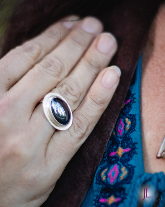 Woman wearing a big oval shaped hematite stone ring