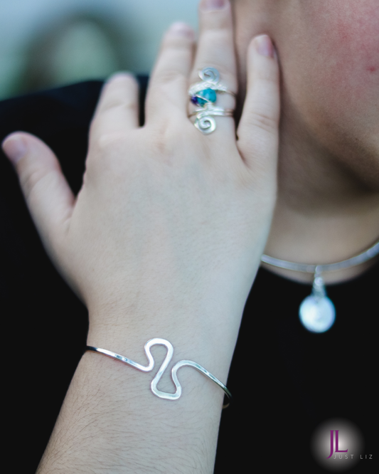 Woman wearing a silver swirly cuff bracelet