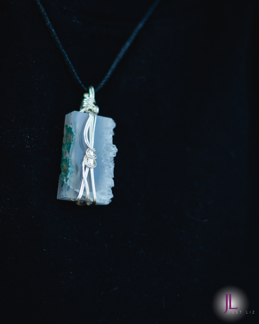 Woman wearing a blue and green druzy stone necklace
